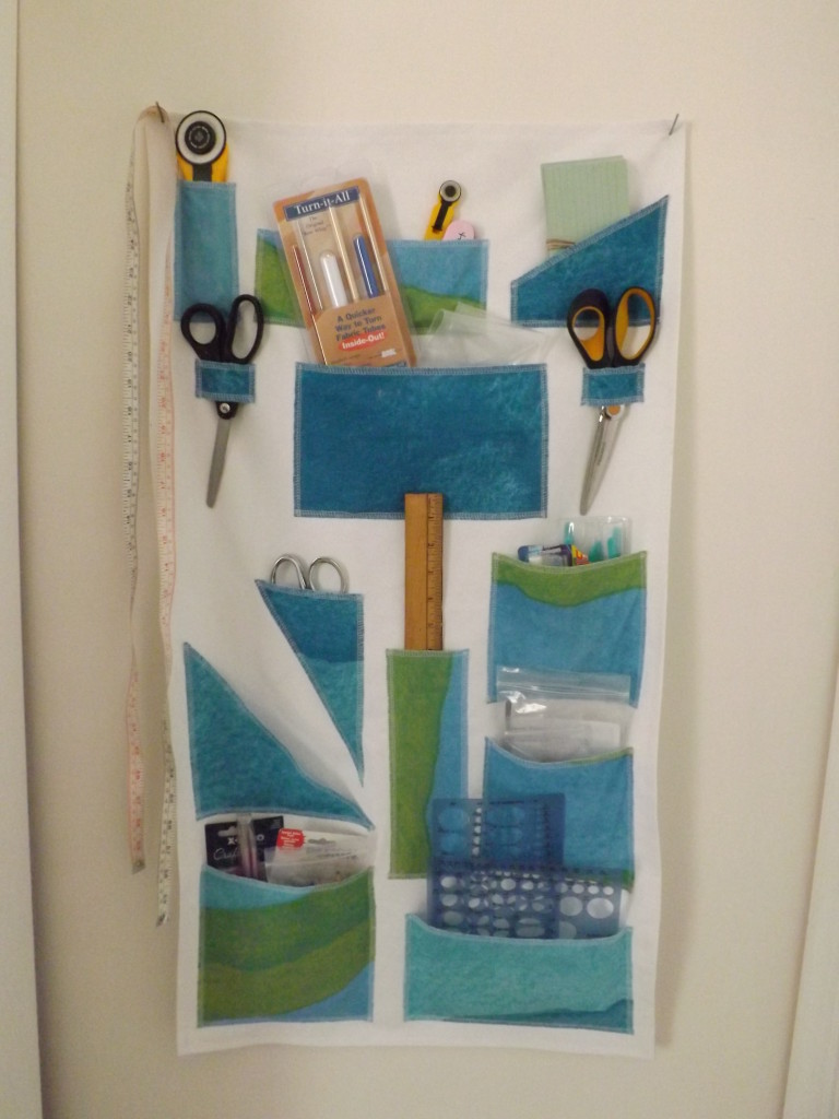 A photo of a white and blue fabric wall organizer.