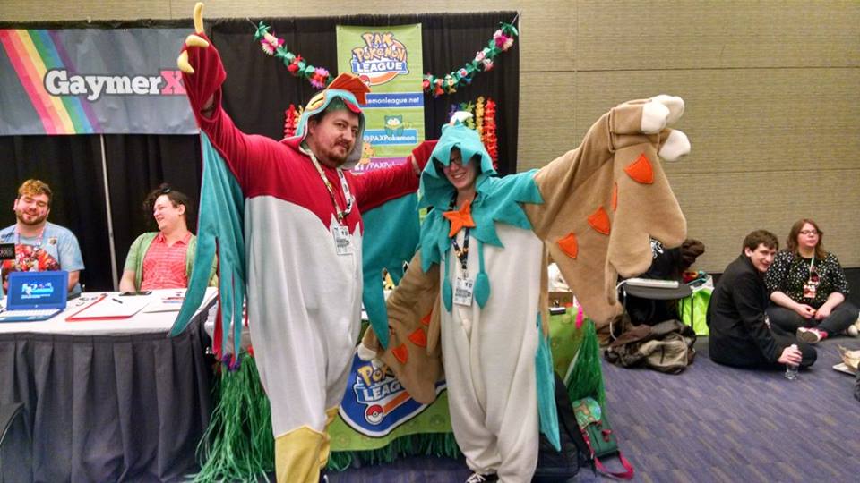 Grant and Alex in their Hawlucha and Decidueye kigus, wings spread wide.