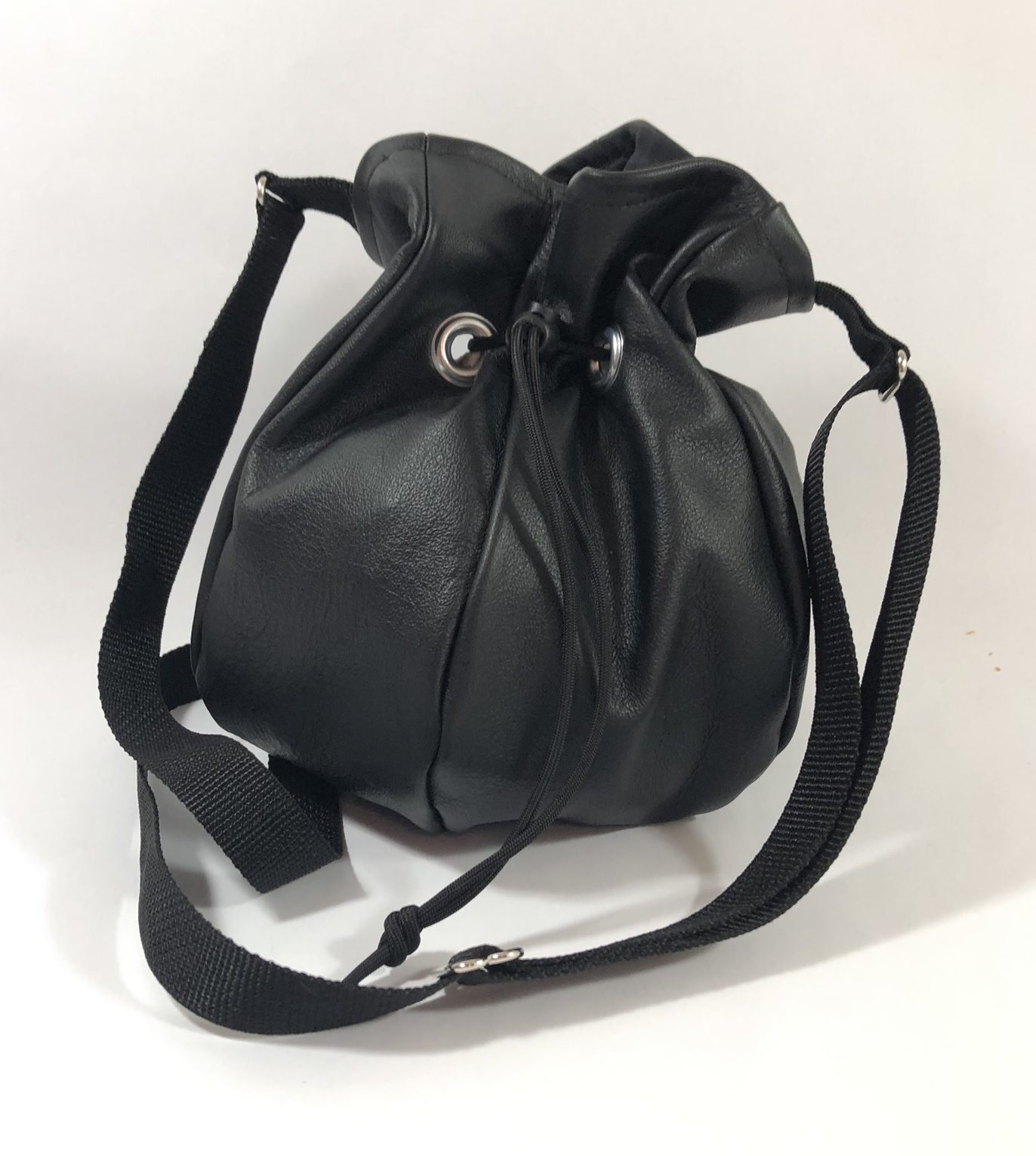Drawstring crossbody handbag made from black leather.
