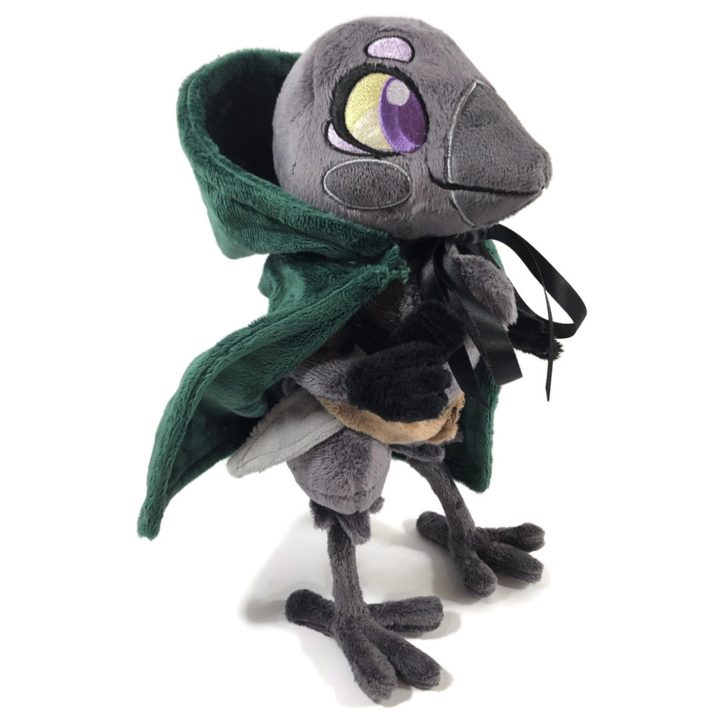 plush gray anthropomorphic crow with embroidered eyes, a green cloak, and a fabric dagger in her belt