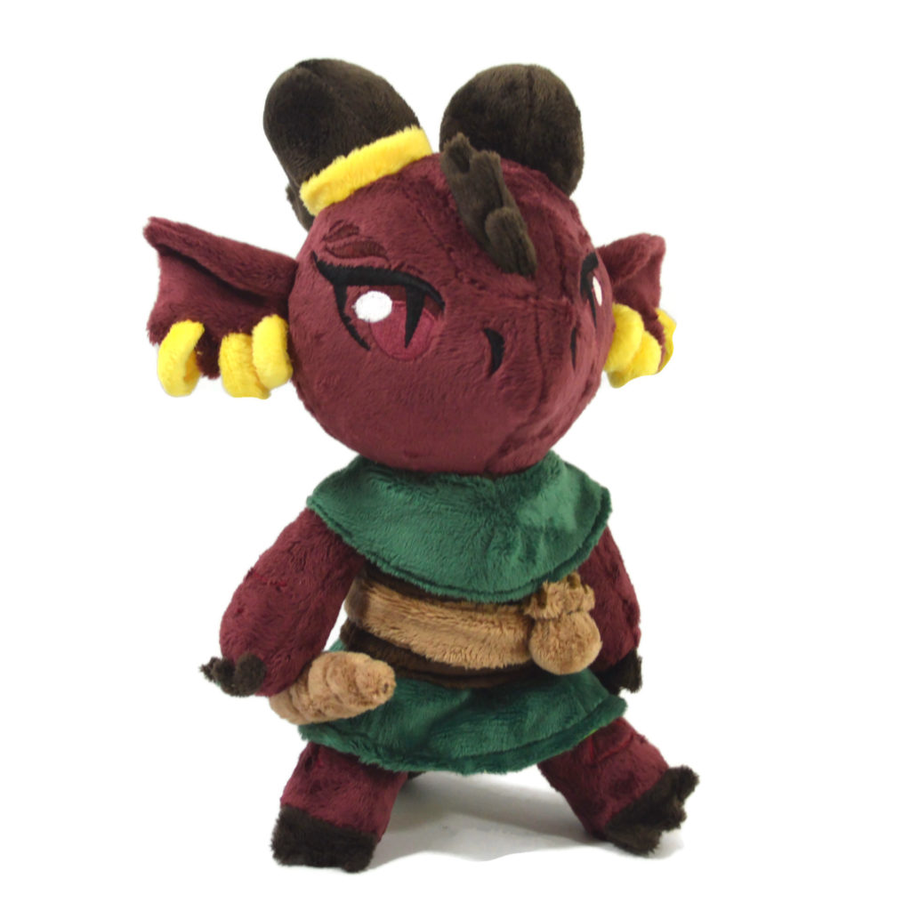 A red Kobold plush with brown horns and a green outfit.