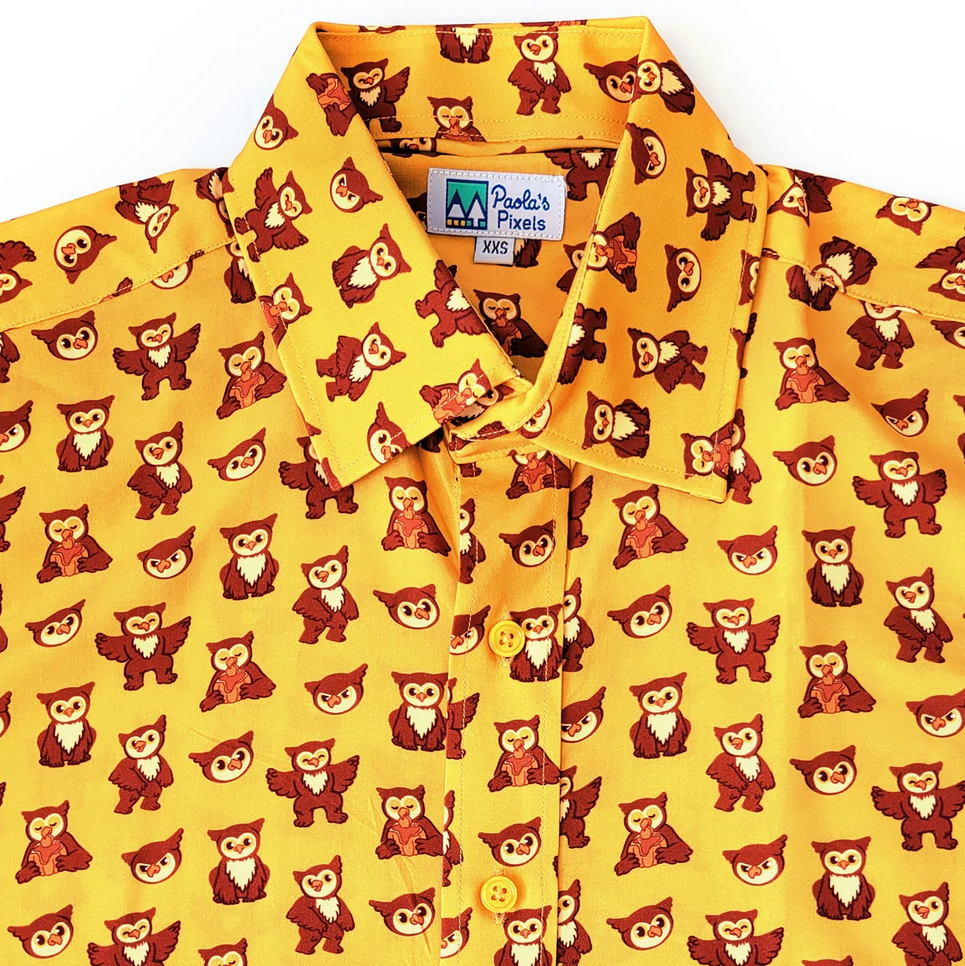 Photo of a yellow buttondown shirt with little owlbears on it by Paola's Pixels.